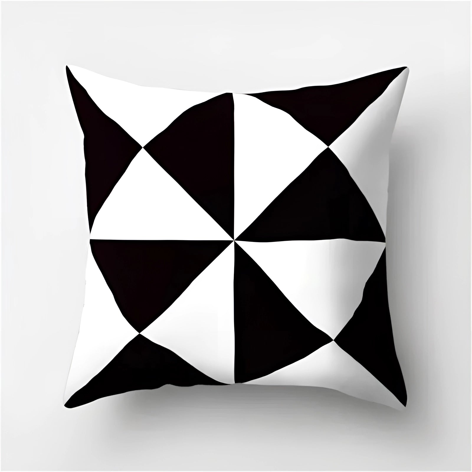 Geometric black and white pillow featuring modern abstract patterns with symmetrical designs, suitable for contemporary home decor.
