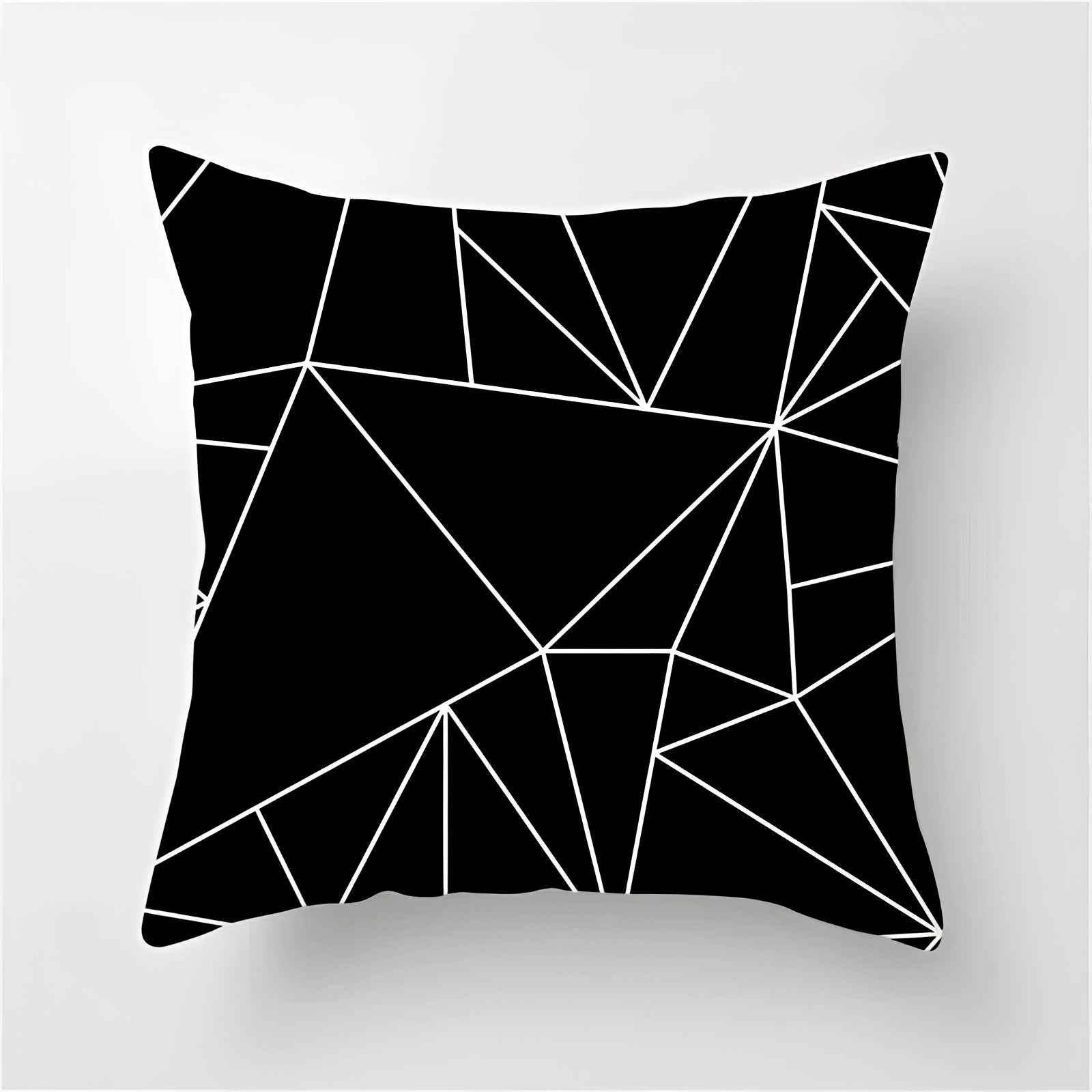 Geometric black and white pillow with a modern abstract design, featuring intricate patterns and artistic illustrations, measuring 60 x 60 cm.
