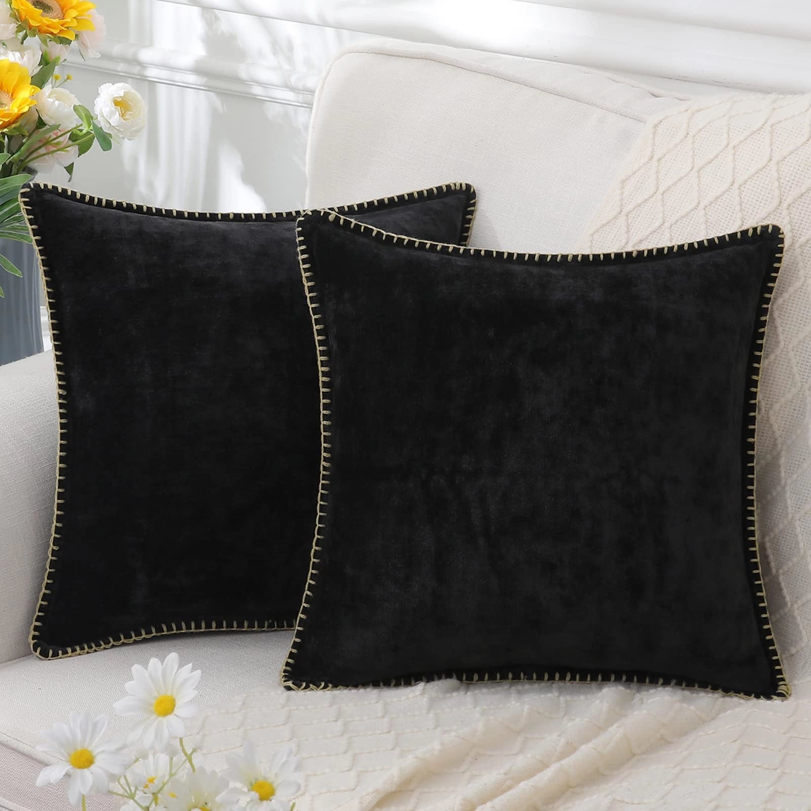 Dark blue velvet throw pillows in a set of four, featuring a soft and elegant design, displayed with a stylish azure and denim pattern.